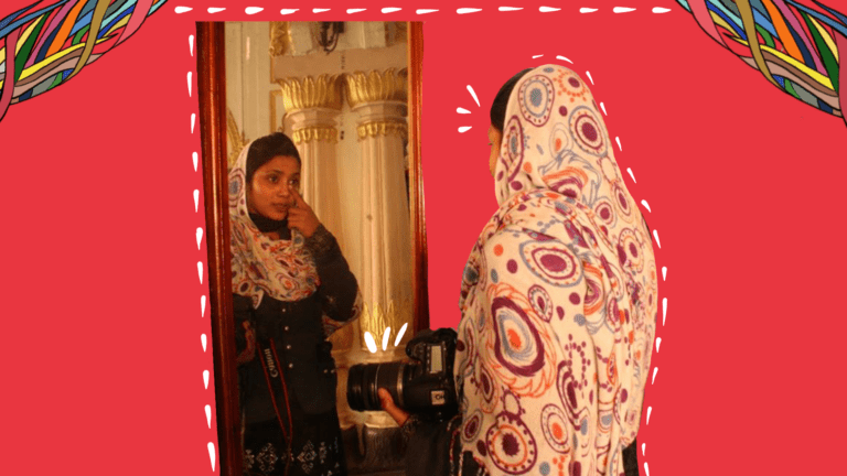 On a rectangle red background, there are colourful story threads at the edges at the top of the image. There is an image of a girl wearing a headscarf, looking in the mirror. She is holding a camera is her left hand. Below the image is a black box that says, 'Identity'.